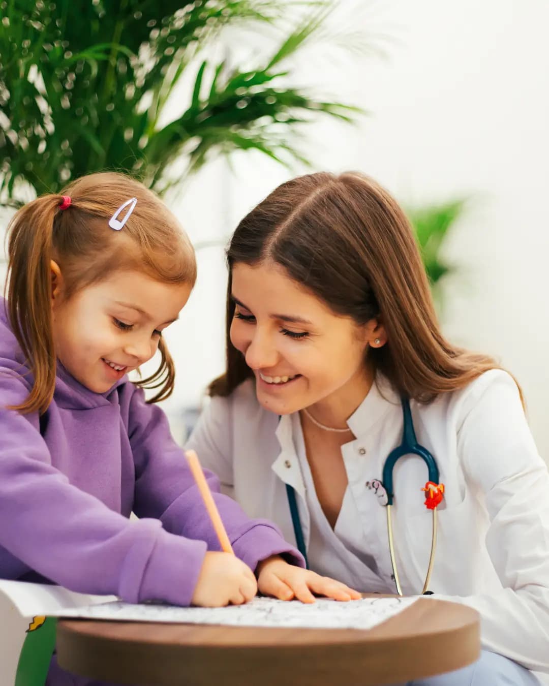 Pediatrician warmly engaging with a young patient
