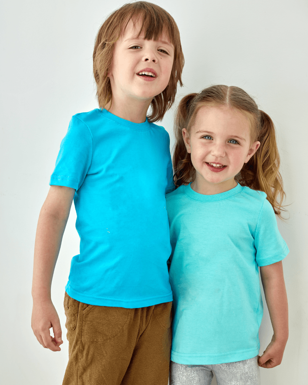 Two young siblings smiling